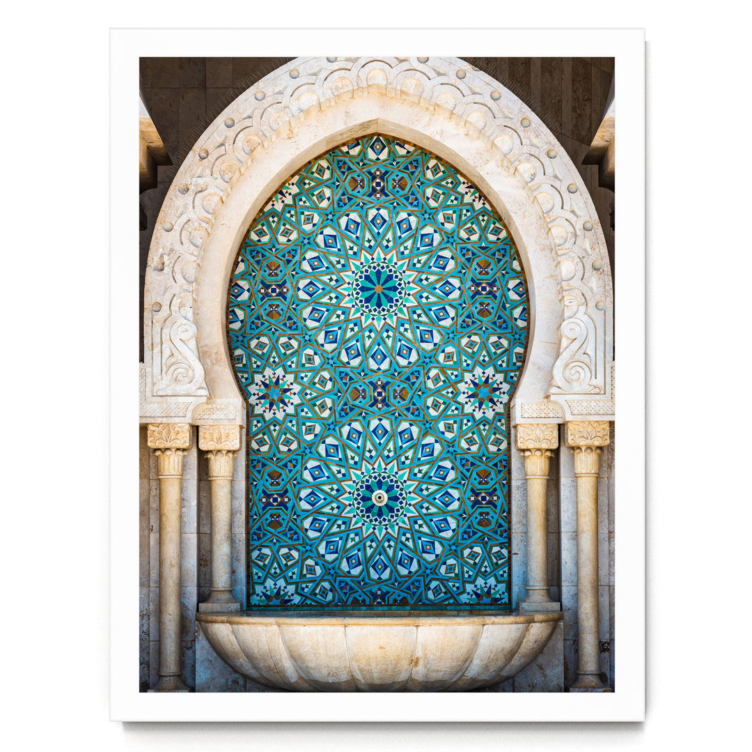 a large, ornate fountain with a blue and white tile design. The fountain is set within an arched structure, which adds to its grandeur and architectural appeal. The overall composition of the image is visually striking and captures the viewer's attention.