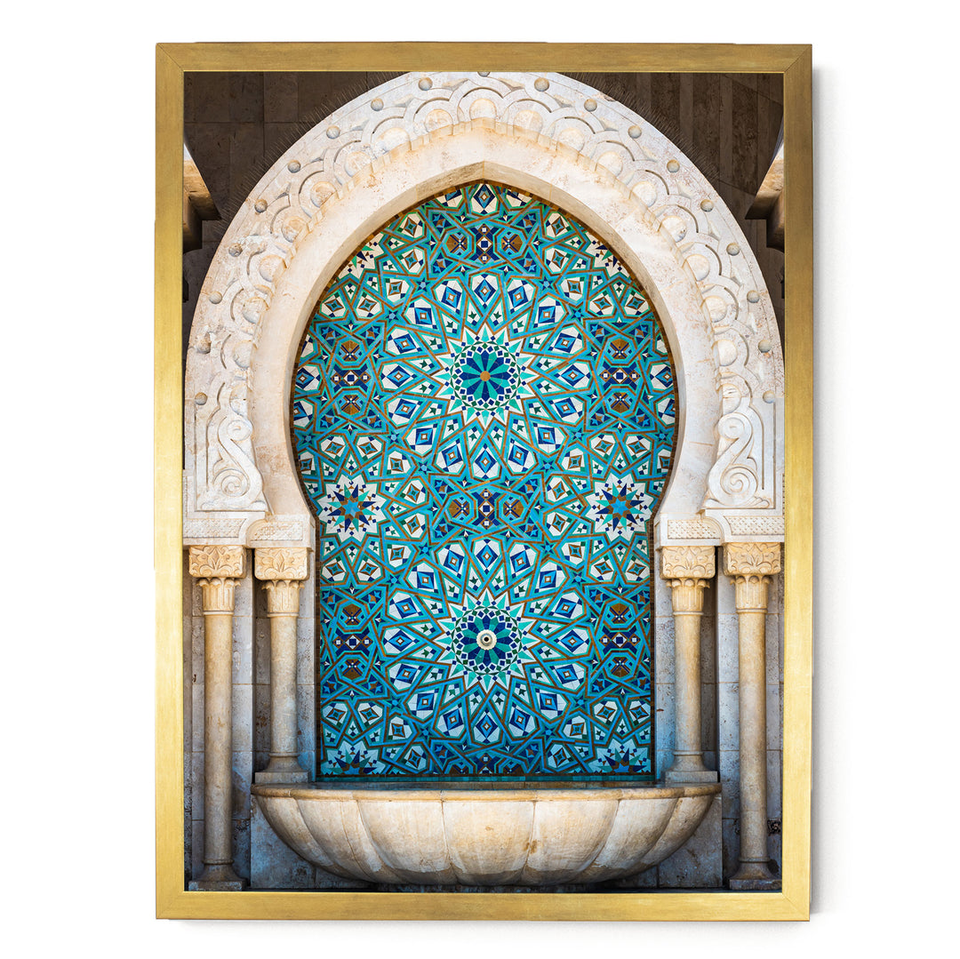 a large, ornate archway with intricate blue and white tile patterns. The archway is framed in gold and is part of a larger architectural structure.