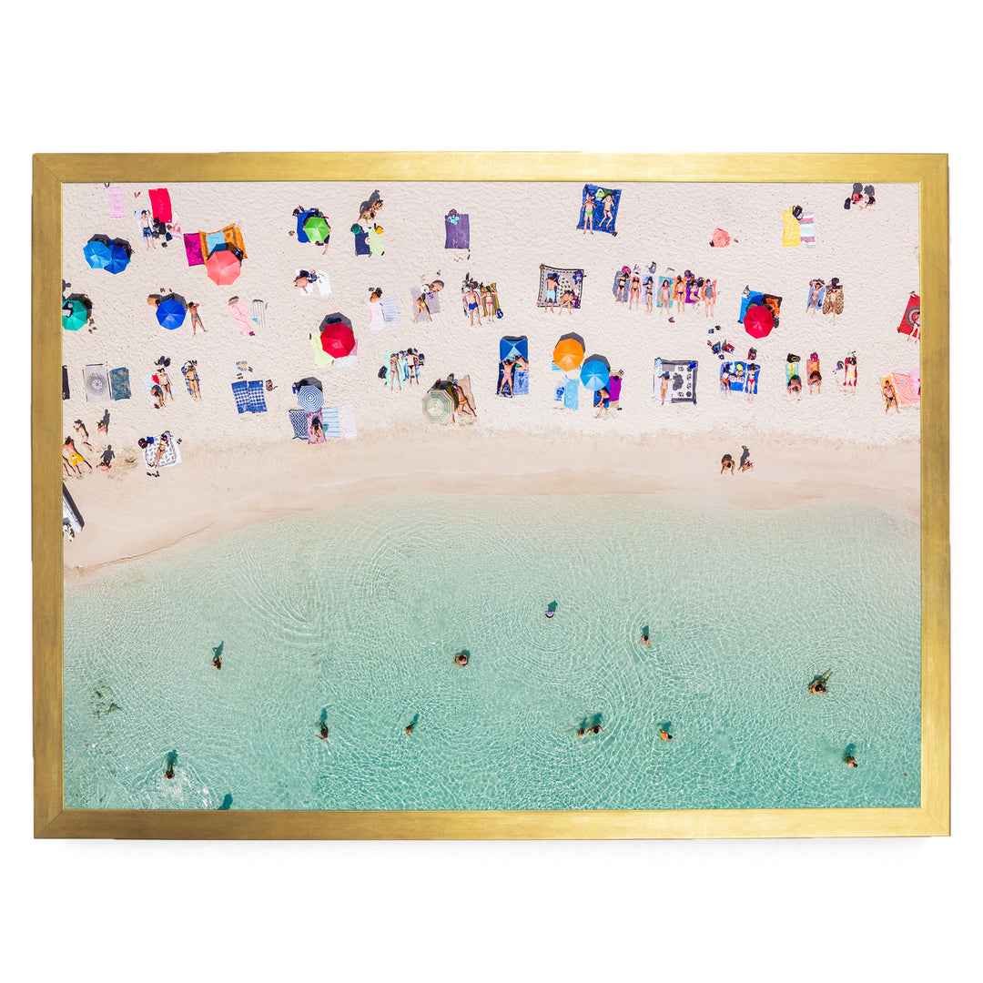 a crowded beach with numerous people enjoying the sun, sand, and water.
