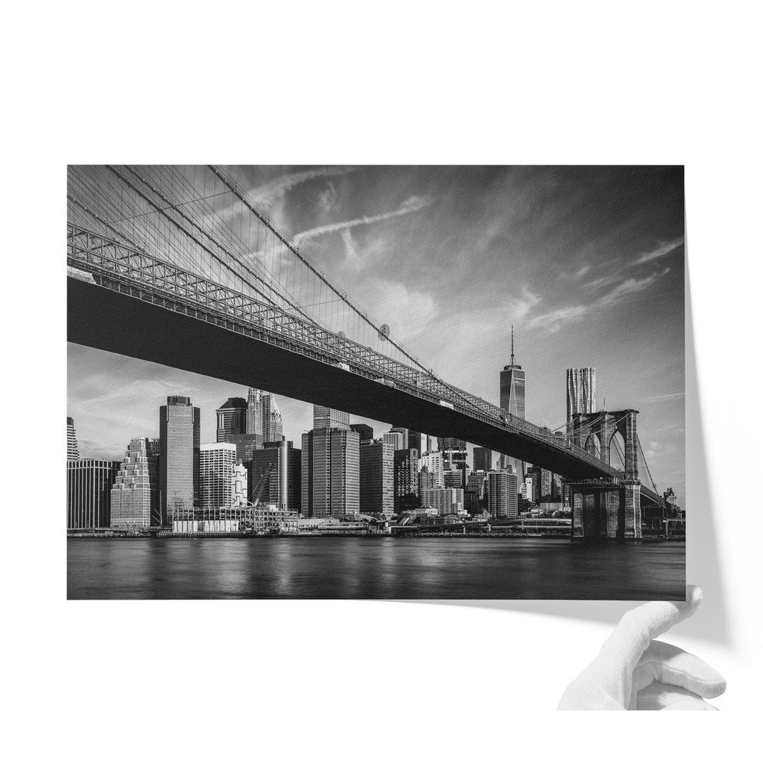 a black and white photo of a bridge and a city