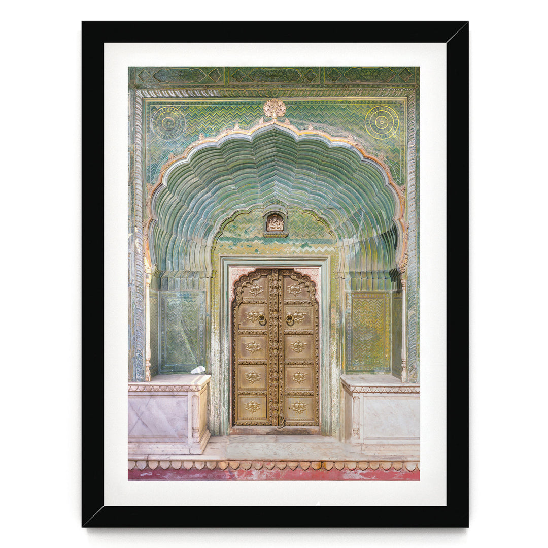 a large, ornate golden door with intricate carvings and patterns, set within an elaborate archway.