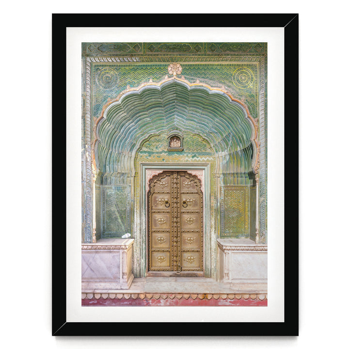 a large, ornate golden door with intricate carvings and patterns, set within an elaborate archway.