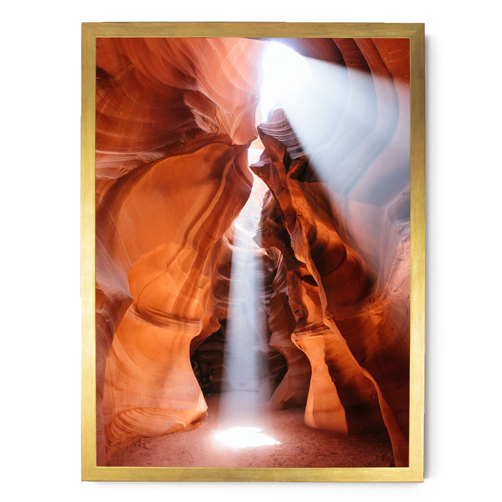 a stunning natural rock formation with a bright light shining through the narrow passage, creating a dramatic and captivating scene.