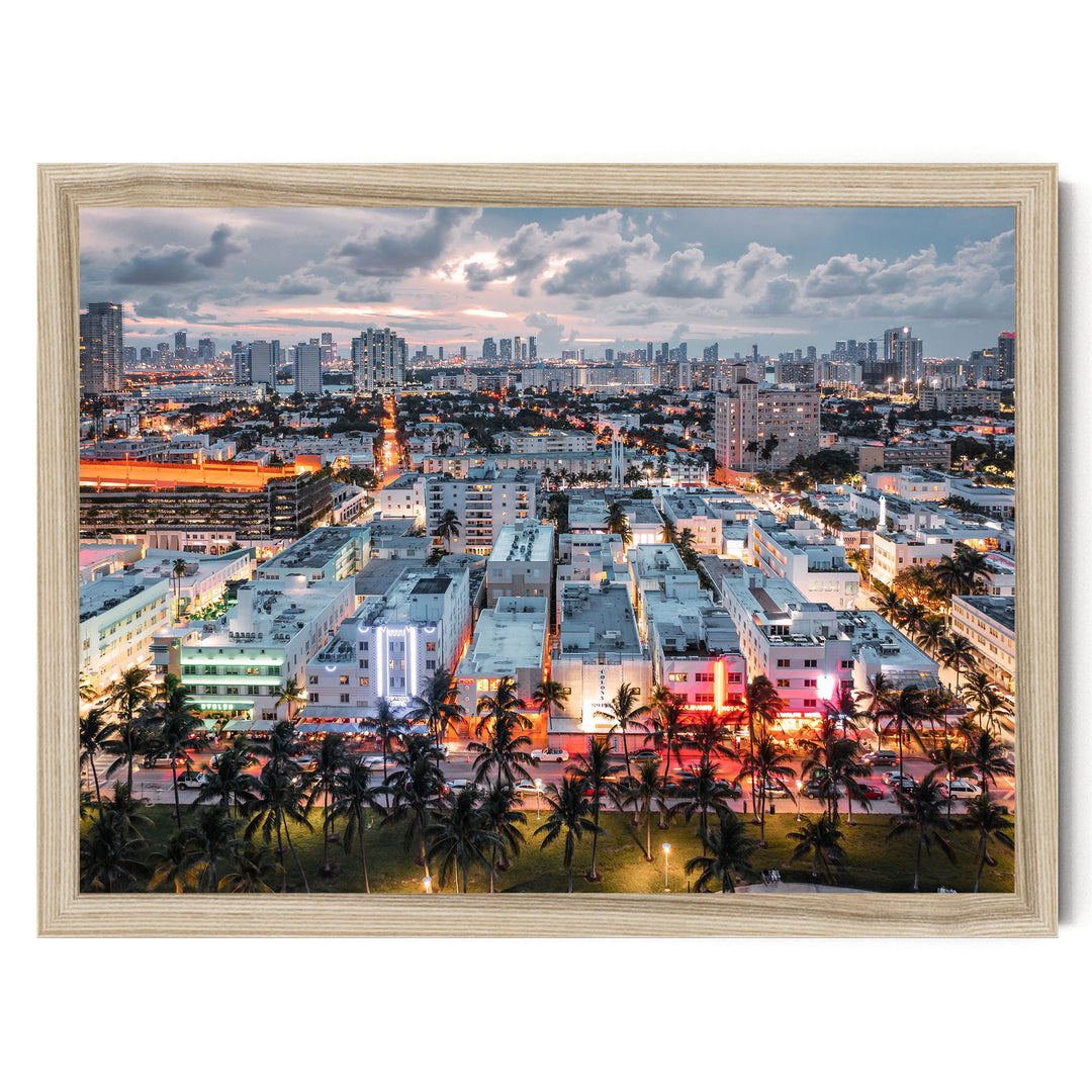 a vibrant cityscape at night, with a skyline of tall buildings illuminated by colorful lights. Palm trees line the streets, adding a tropical touch to the urban landscape.