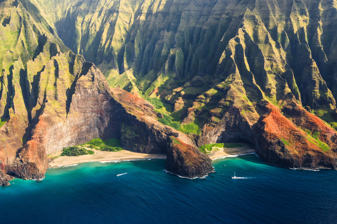 a stunning coastal landscape with towering cliffs, a sandy beach, and a turquoise ocean.