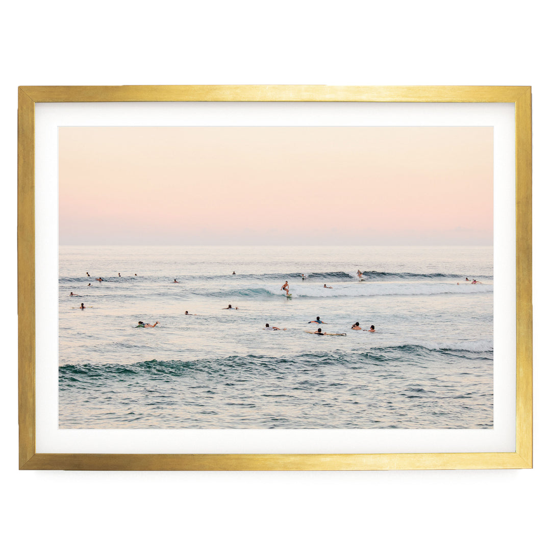 a group of people enjoying themselves in the ocean, with some of them riding waves on surfboards.