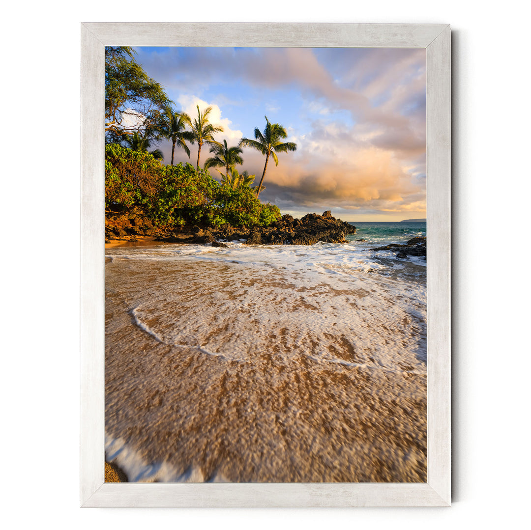 A serene beach scene with palm trees, crashing waves, and a picturesque sunset over the ocean.