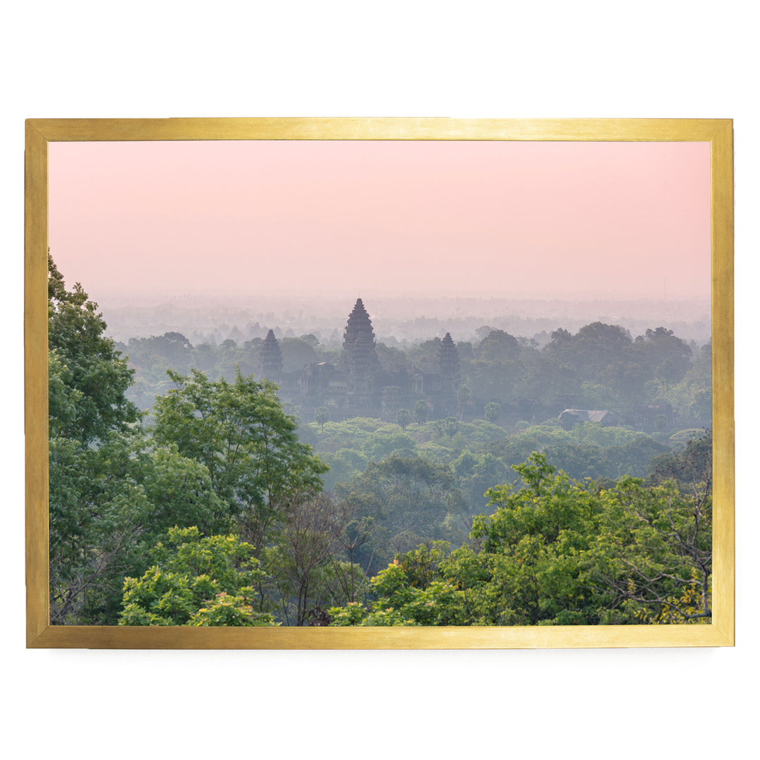 a lush, verdant landscape with a dense forest in the foreground and a temple visible in the distance.