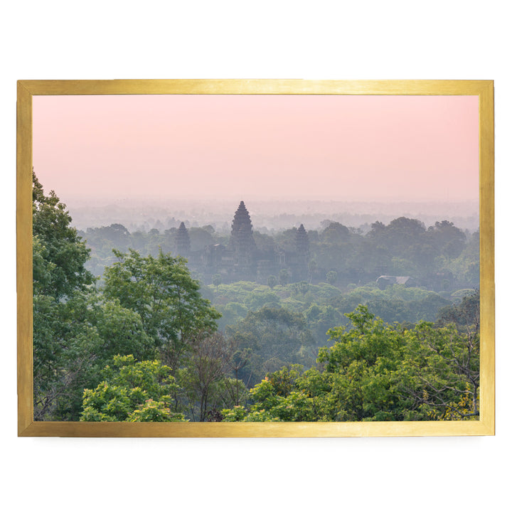 a lush, verdant landscape with a dense forest in the foreground and a temple visible in the distance.