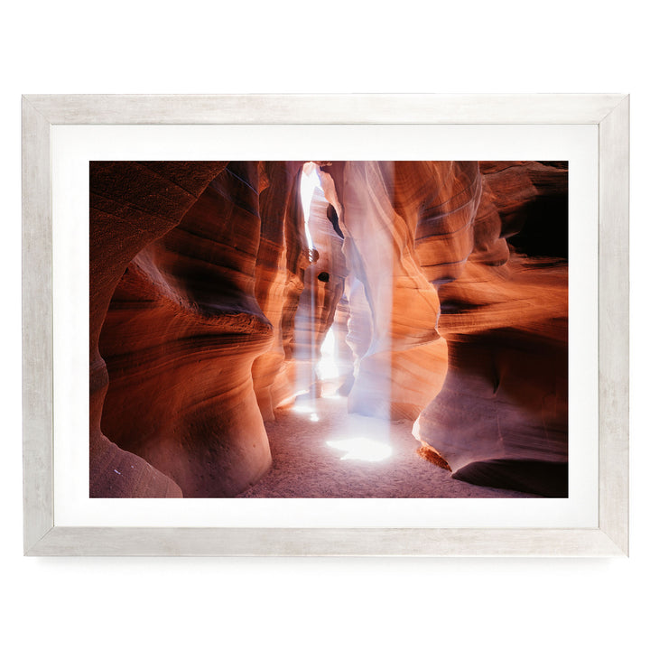 a narrow passage in a canyon, with sunlight streaming through the walls and creating a dramatic, ethereal atmosphere.