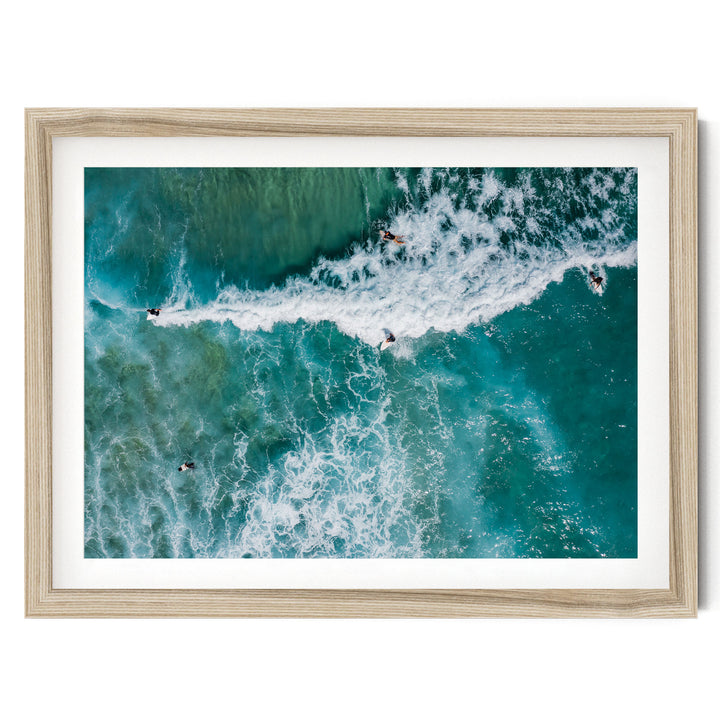 a group of people surfing on a large, foamy wave in the ocean.