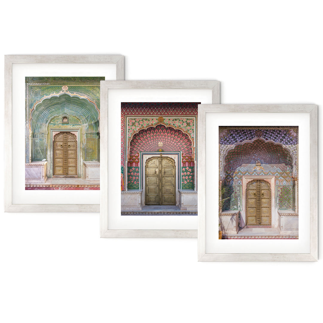 three framed paintings of doors in a building