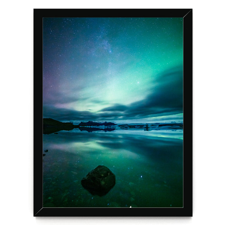 a serene night scene with a starry sky reflected in a calm body of water, creating a beautiful and tranquil atmosphere.
