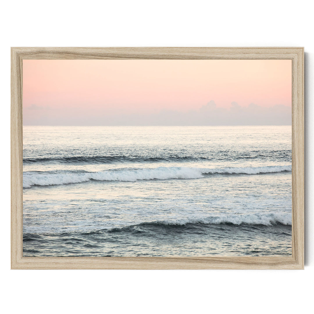 A serene ocean scene with waves gently lapping against the shore, framed in a wooden frame.