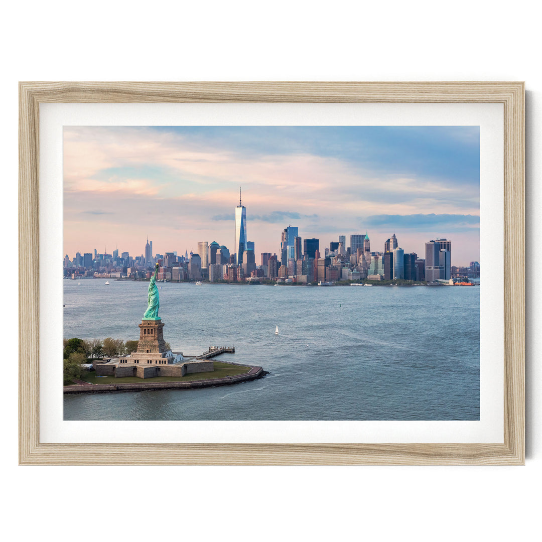 a framed view of the Statue of Liberty in New York City, with the city skyline in the background.