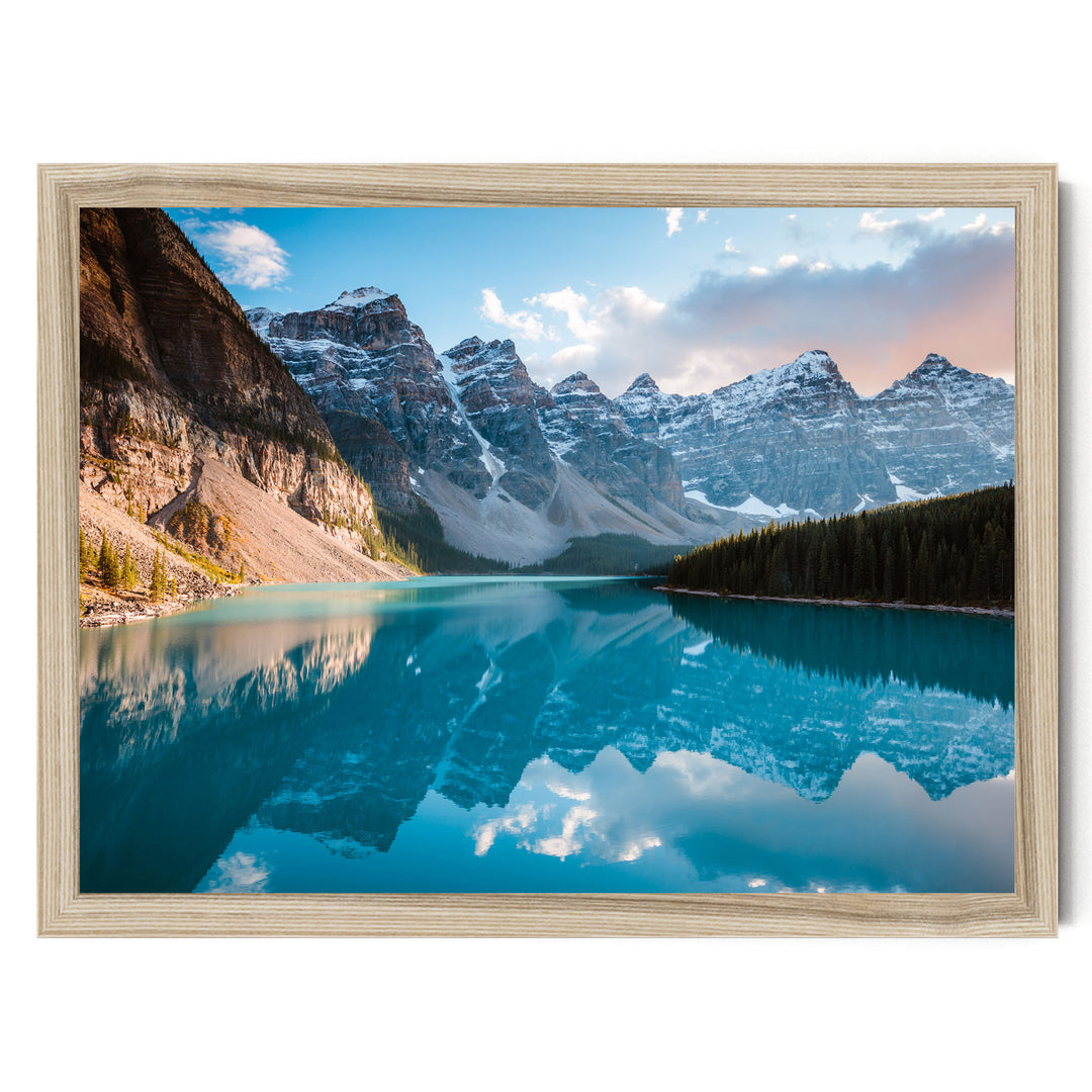 a serene mountain landscape with a deep blue lake reflecting the surrounding peaks and sky.