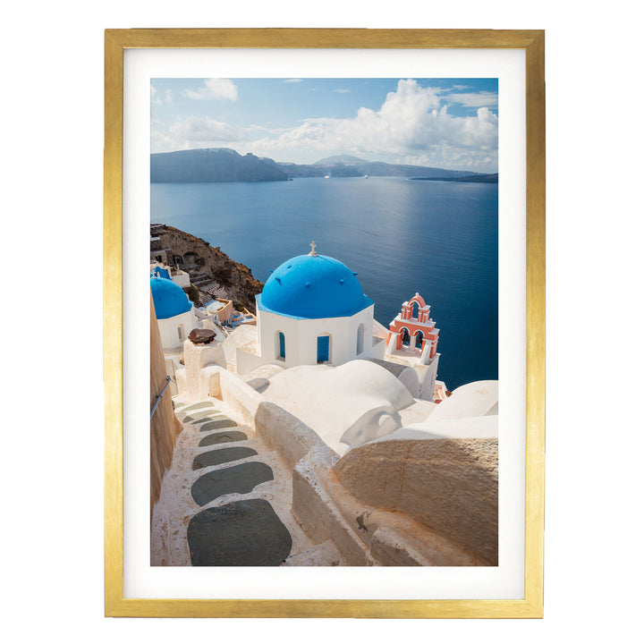 a picturesque view of the Greek island of Santorini, with its iconic blue domes and white buildings overlooking the deep blue waters of the Aegean Sea.