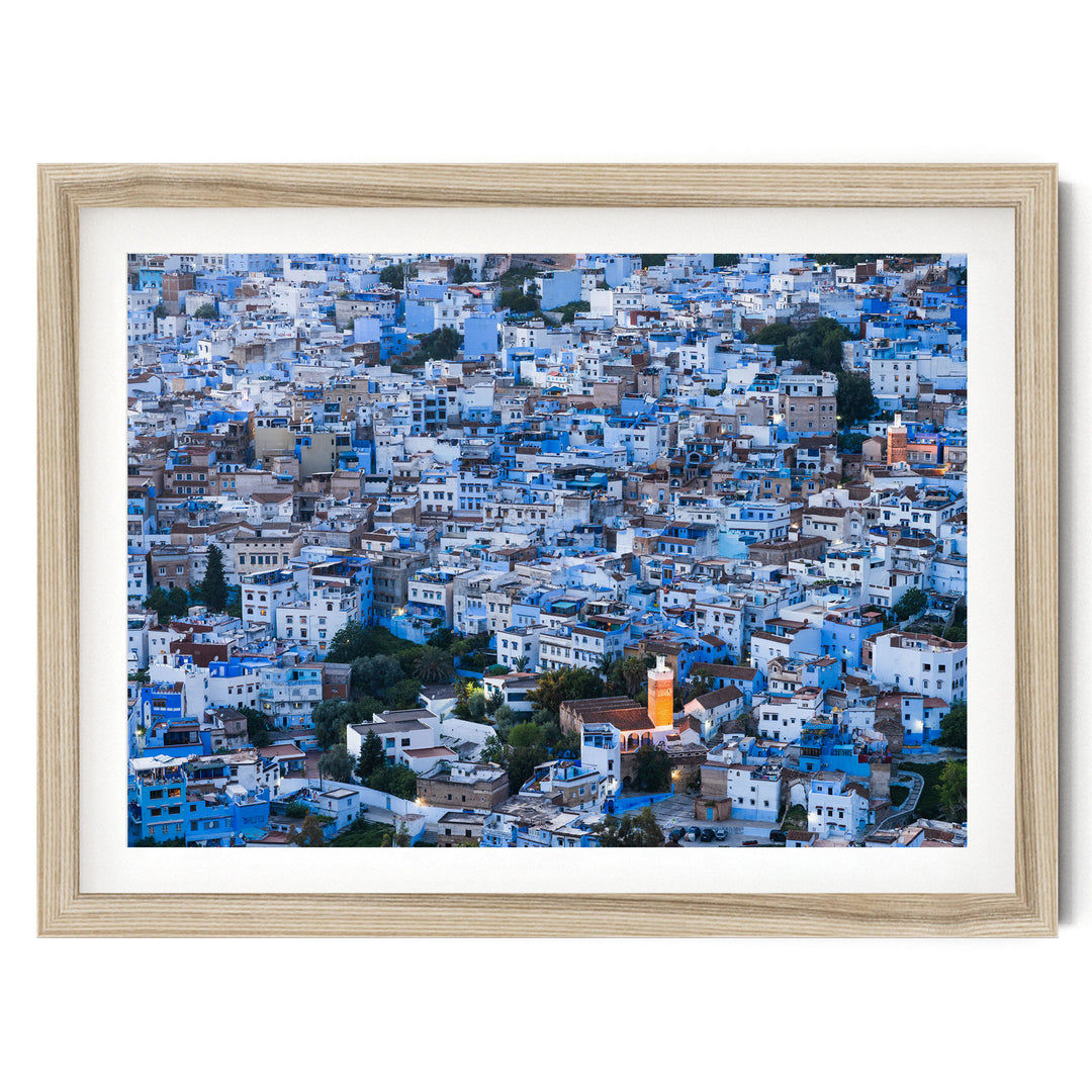 The image is a densely packed cityscape with numerous buildings in shades of blue and white, creating a visually striking and vibrant urban landscape.