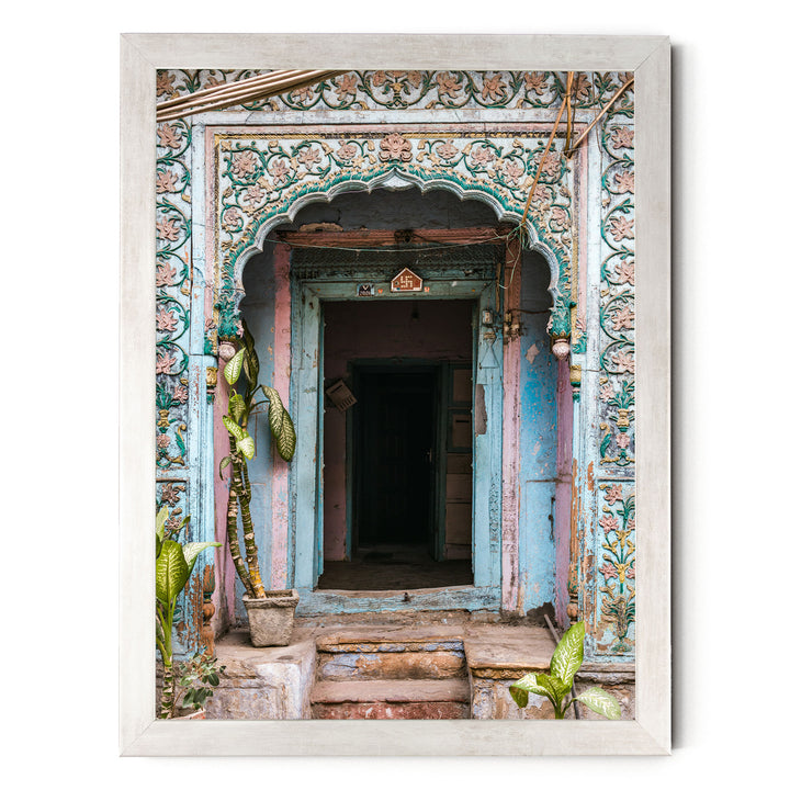 a colorful, ornately decorated doorway with a wooden frame, featuring intricate floral patterns and a small archway.