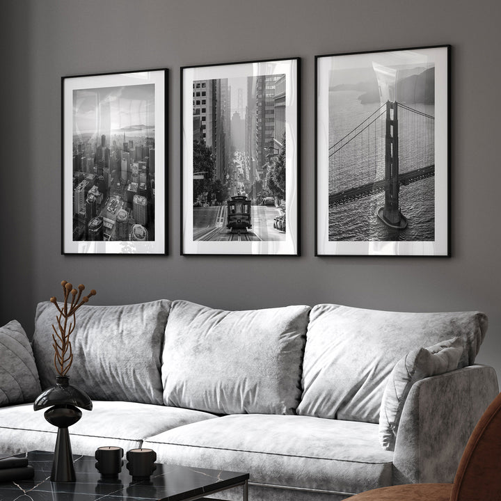 a living room with a couch and three pictures on the wall