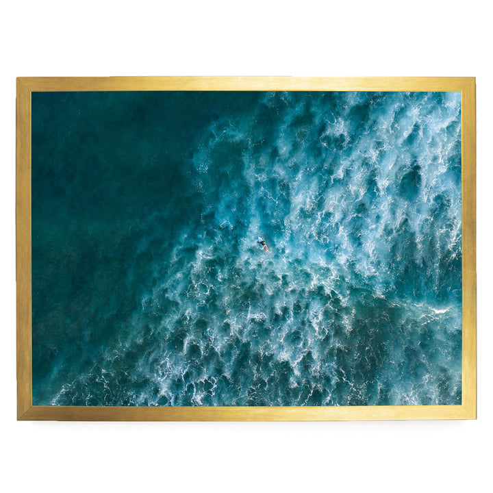 a surfer riding a wave in the ocean, with the wave's crest curling over and creating a dynamic scene.