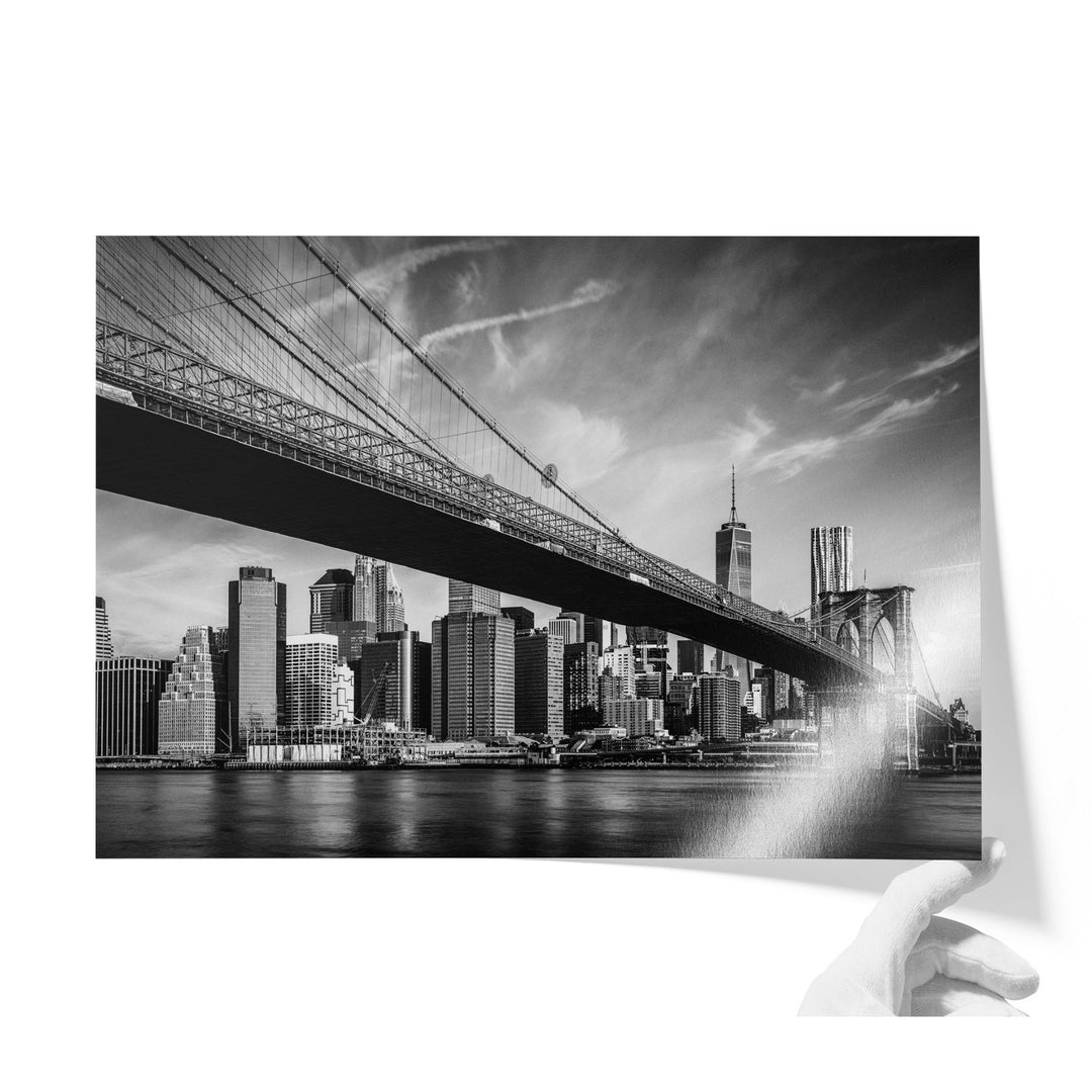 a black and white photo of a bridge and a city