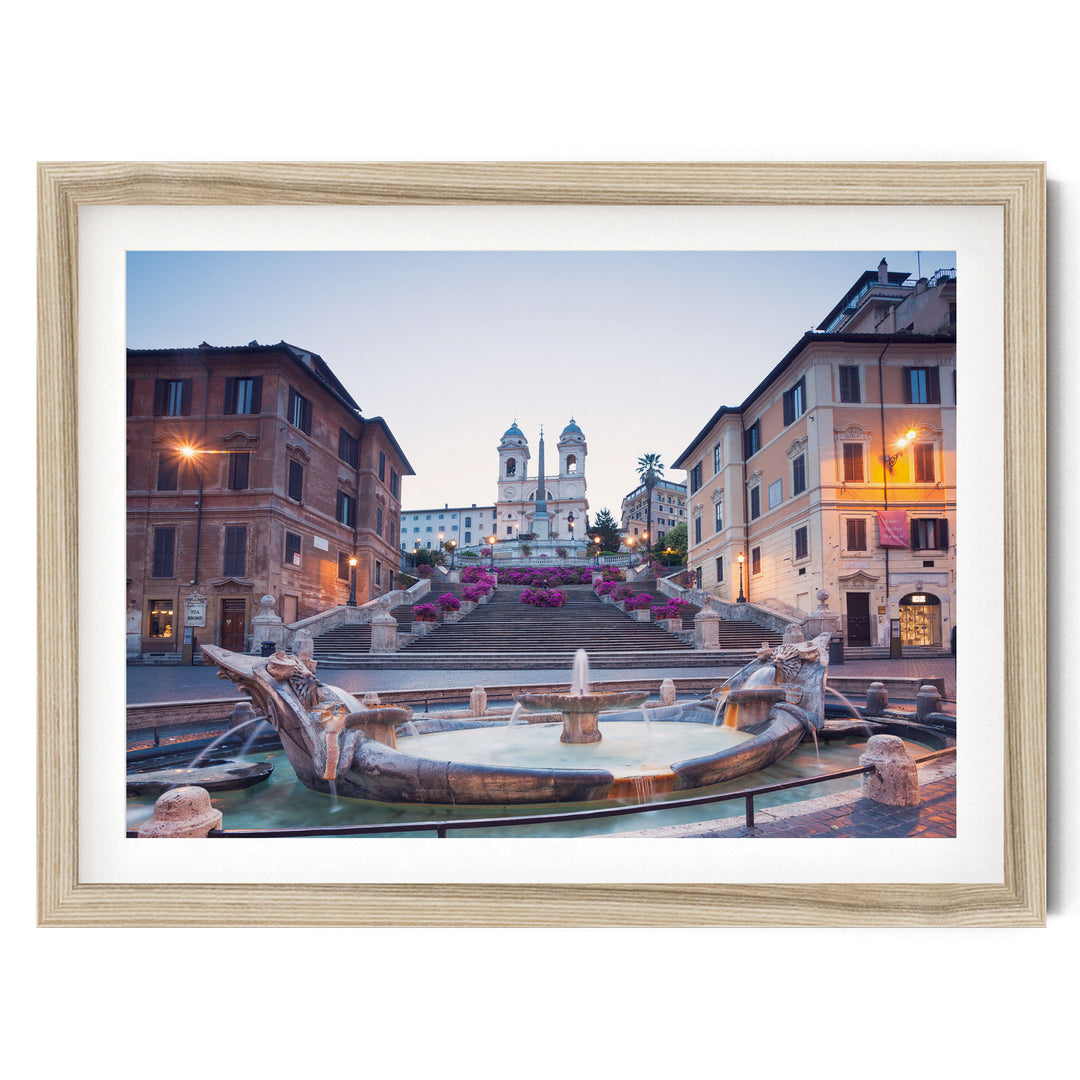 a picturesque scene of a fountain surrounded by ornate buildings, with a church steeple visible in the background.