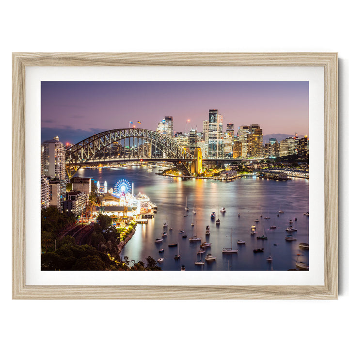 a cityscape at night, with a large bridge spanning a river filled with boats. The city skyline is illuminated, creating a vibrant and lively atmosphere.