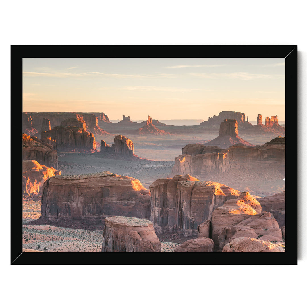a breathtaking view of the Grand Canyon, showcasing its vast and rugged landscape with towering rock formations bathed in the warm glow of the setting sun.