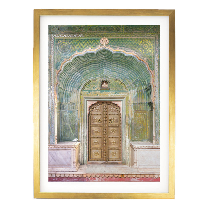 a large, ornate wooden door with intricate carvings and patterns, set within an elaborate archway.