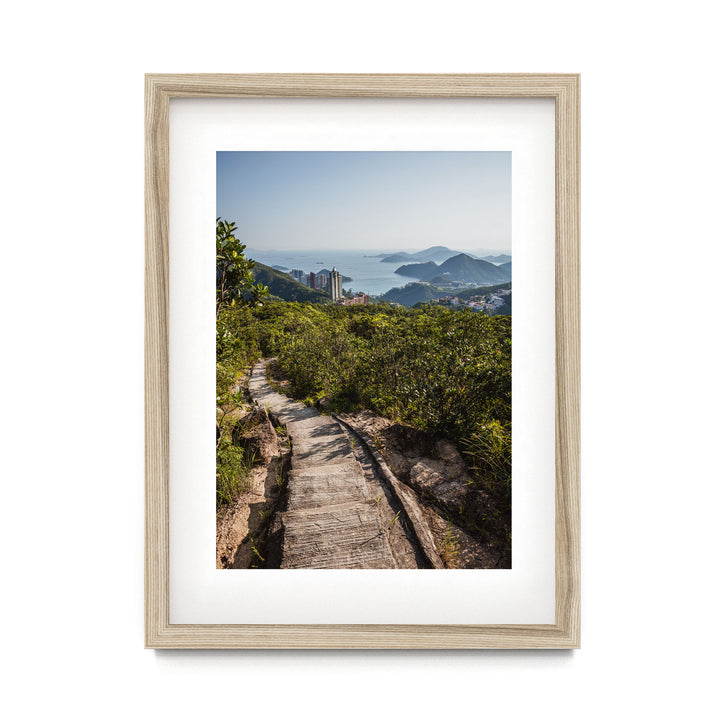 a framed photograph of a path leading to the top of a mountain