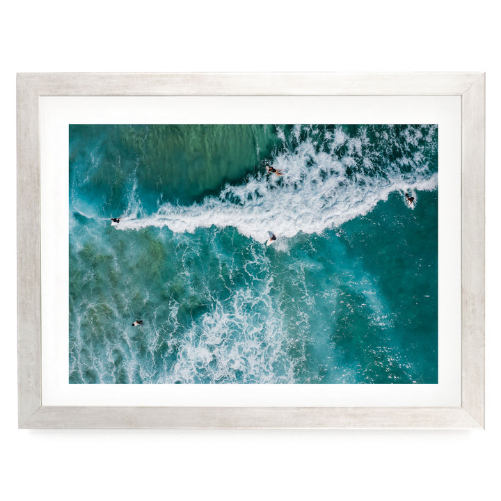 a group of people surfing on a large, foamy wave in the ocean.