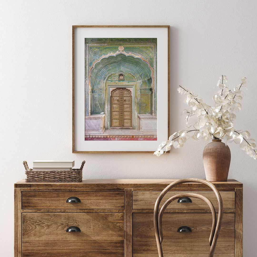 a painting of a doorway on a wall above a dresser