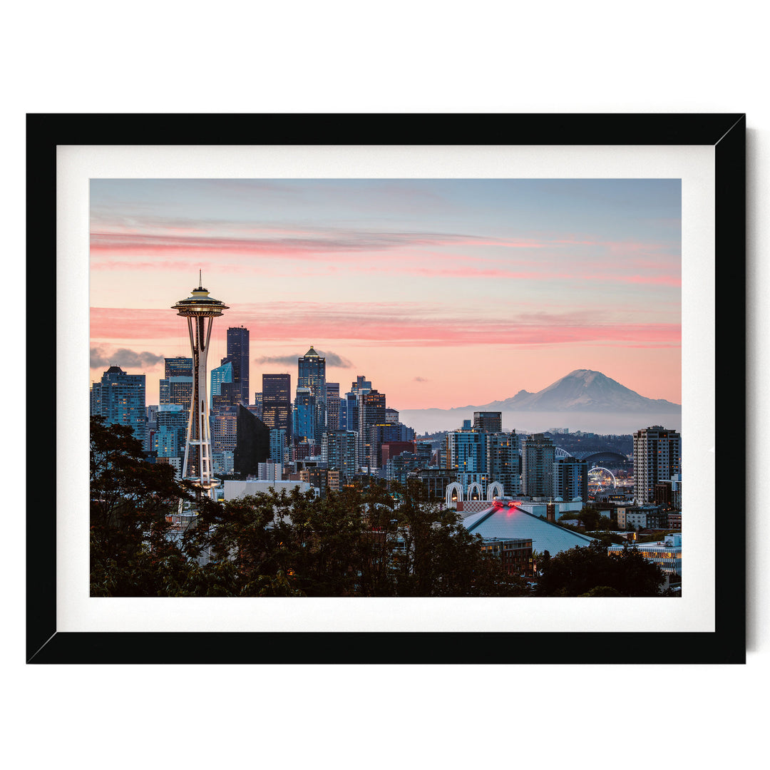 A framed photograph of the Seattle skyline at sunset, with the Space Needle prominently visible in the foreground.