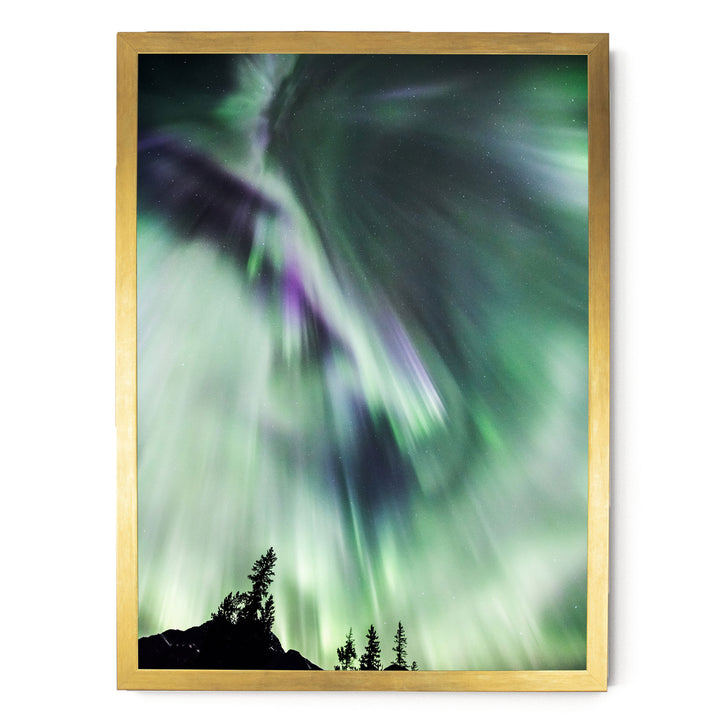 a stunning display of the Aurora Borealis, or Northern Lights, illuminating the night sky with vibrant green and purple hues.