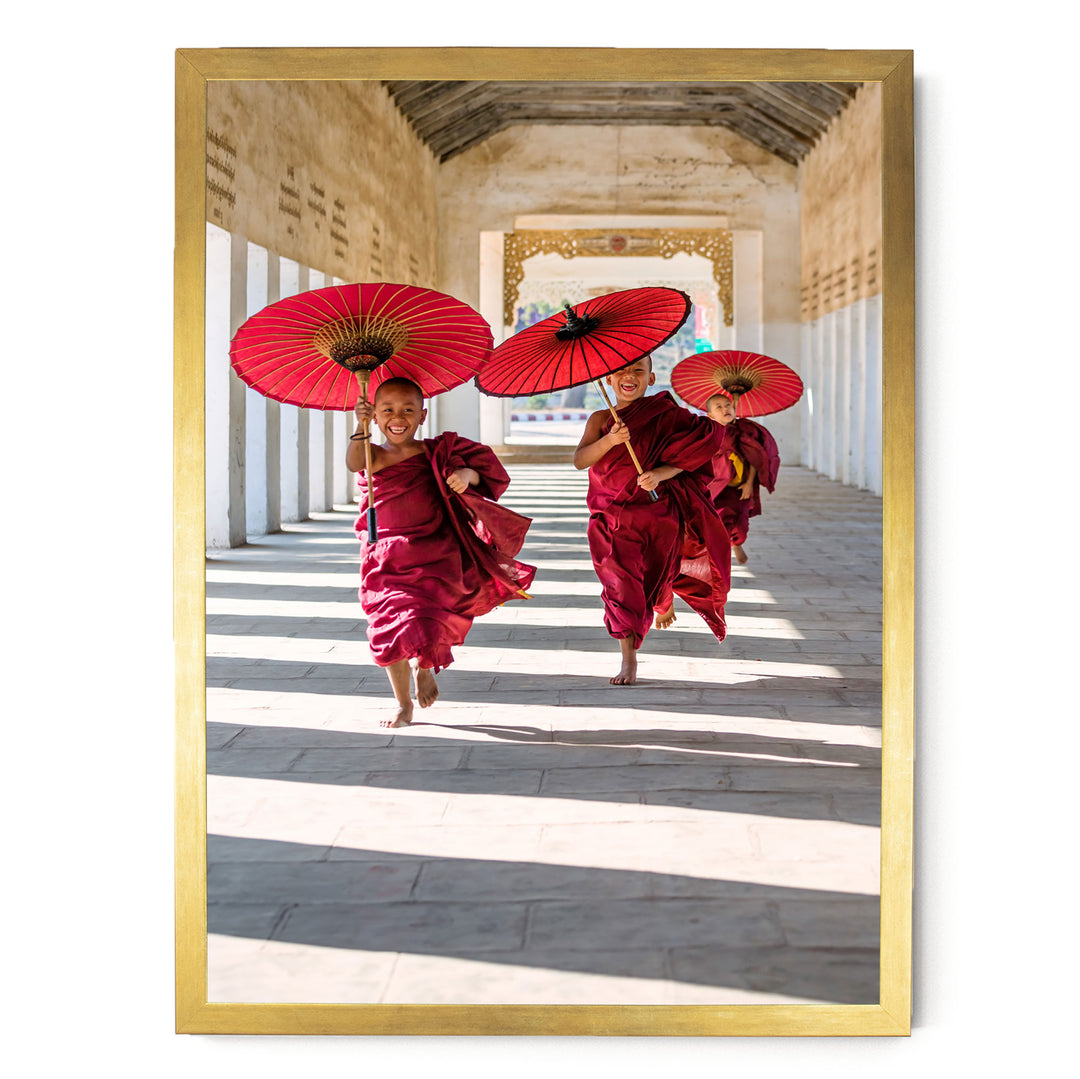 Three monks in red robes are walking down a hallway, each holding a red umbrella.