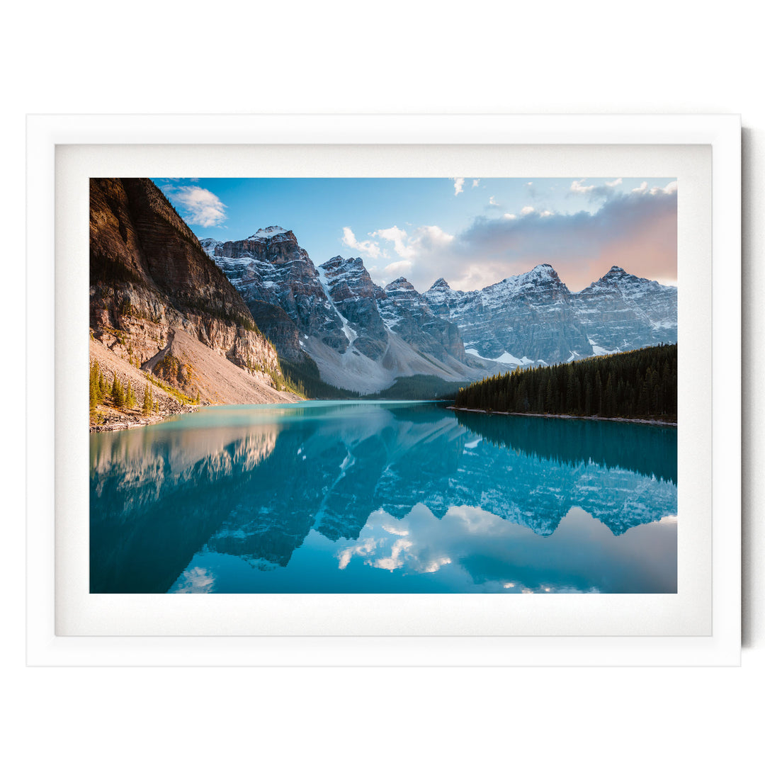 A breathtaking landscape featuring a serene lake surrounded by majestic snow-capped mountains, with the mountains' peaks reflected perfectly in the calm waters.