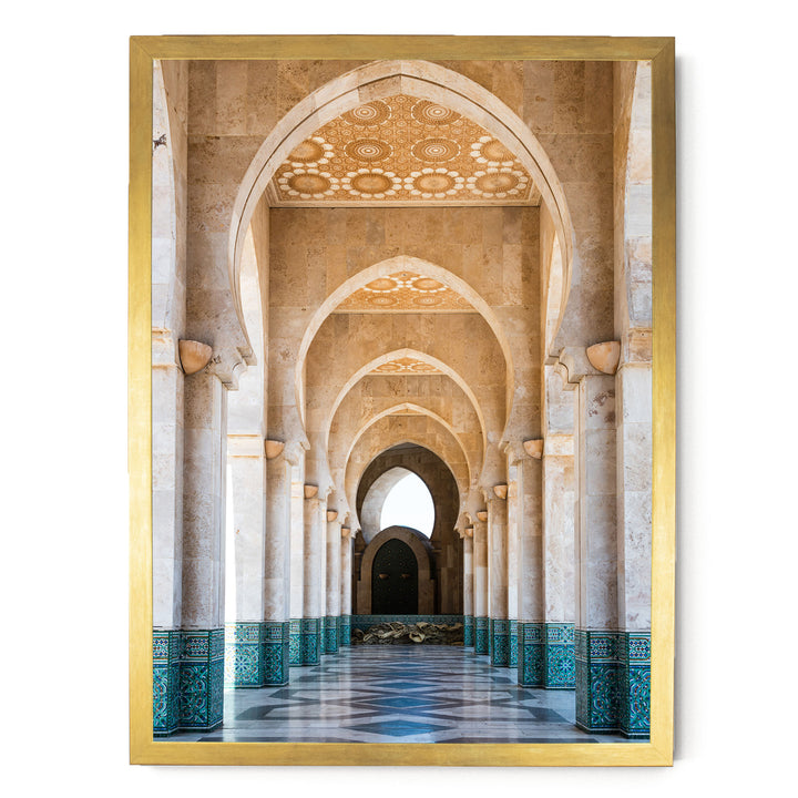 a long, ornate hallway with arched doorways and columns, creating a sense of depth and perspective. The walls are adorned with intricate patterns and designs, adding to the overall aesthetic of the space. The hallway appears to be part of a larger architectural structure, possibly a mosque or a palace, given the grandeur and detailed design.