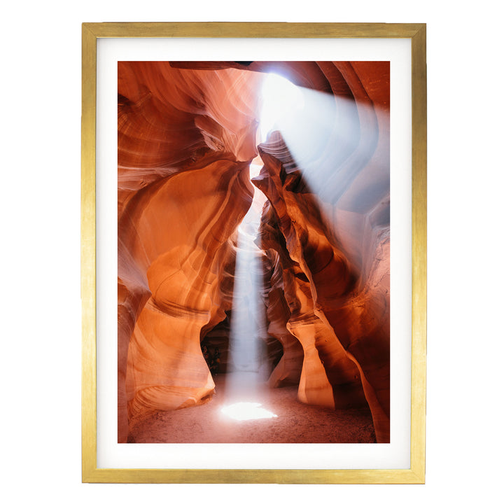 a stunning natural rock formation with a bright light shining through the narrow passage, creating a dramatic and captivating scene.