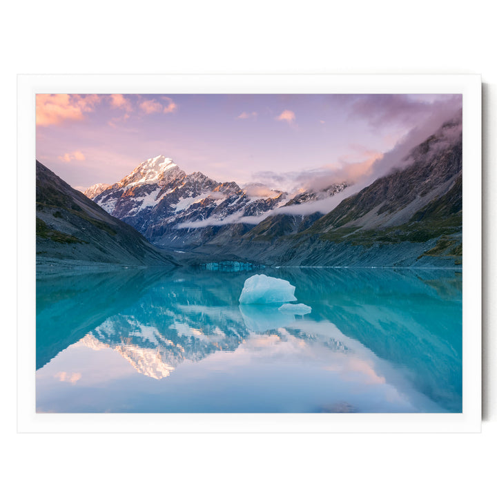 a serene alpine lake surrounded by majestic snow-capped mountains, with a large iceberg floating on the calm, turquoise waters.
