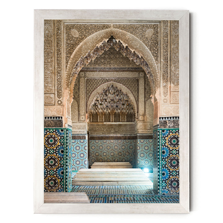 an ornate, intricately decorated interior space with a large archway, tiled walls, and a central platform.