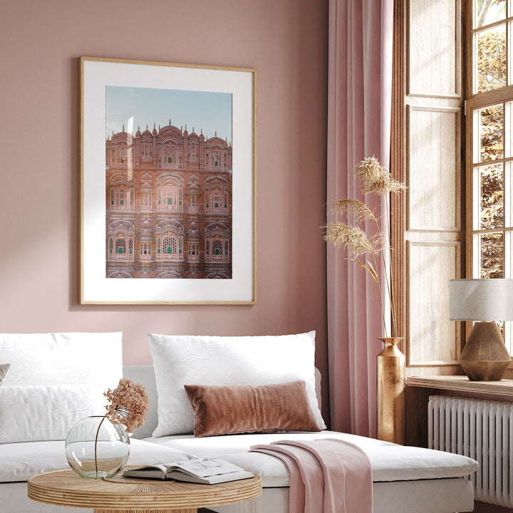 a living room with pink walls and a white couch