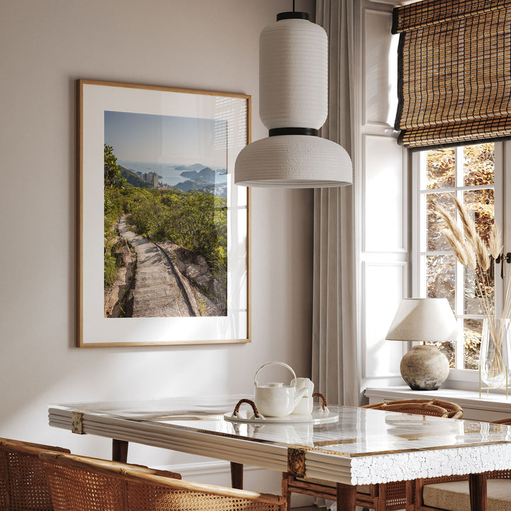 a dining room with a picture hanging on the wall