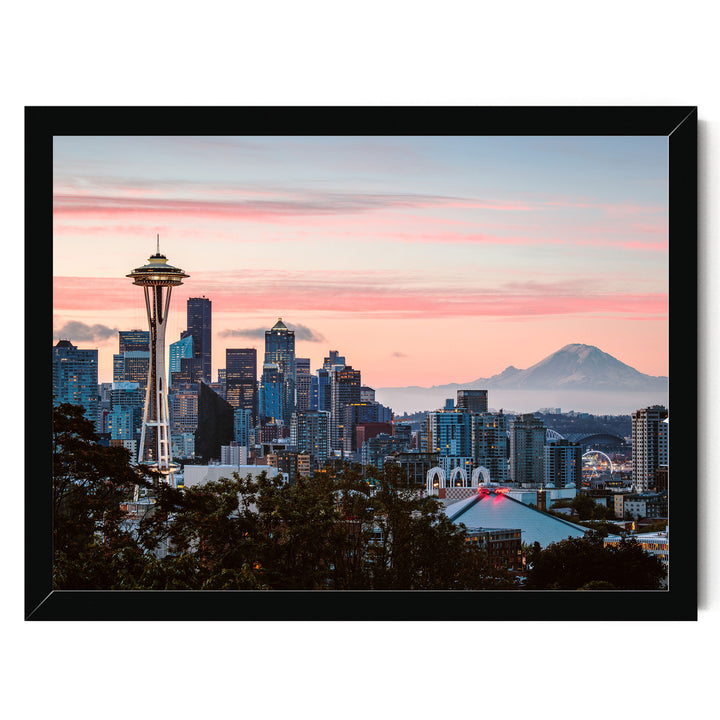 a city skyline at sunset, with the Space Needle and other high-rise buildings silhouetted against a vibrant pink and orange sky.