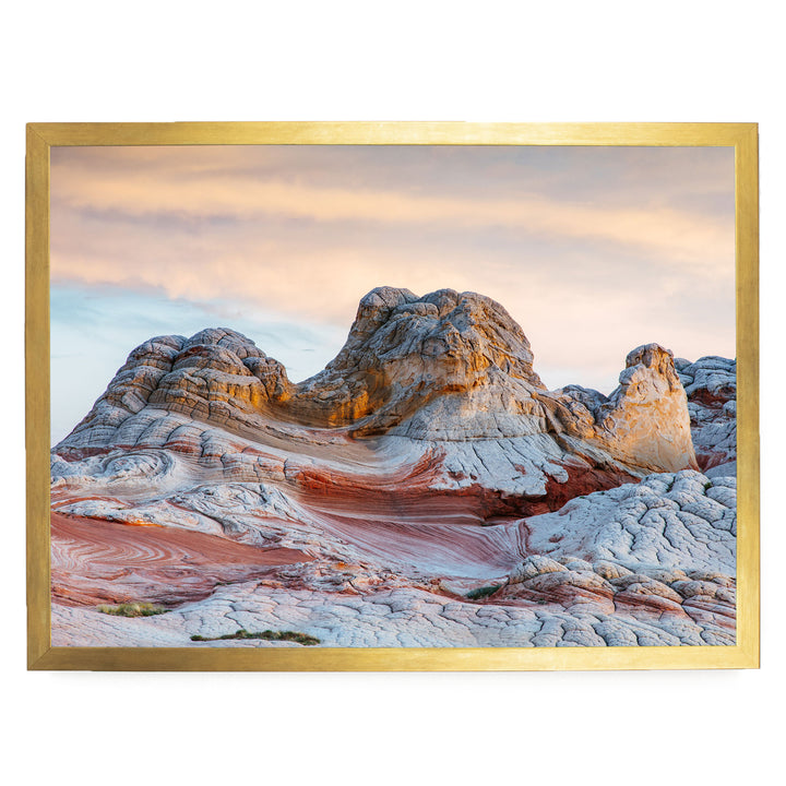 a striking natural landscape with a large, multi-colored rock formation in the foreground, set against a backdrop of a cloudy sky.