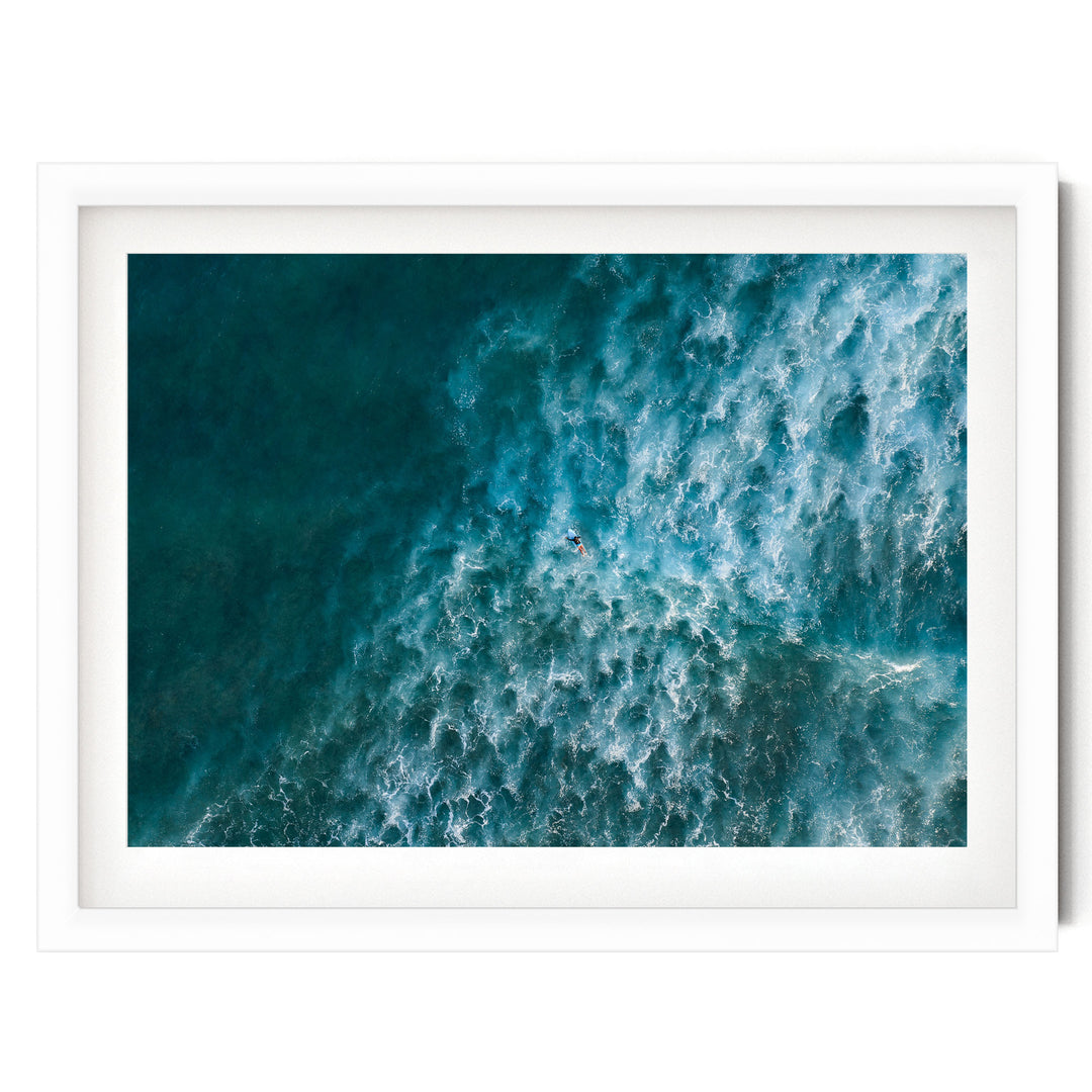 a surfer riding a wave in the ocean, with the wave's crest curling over and creating a dynamic scene.