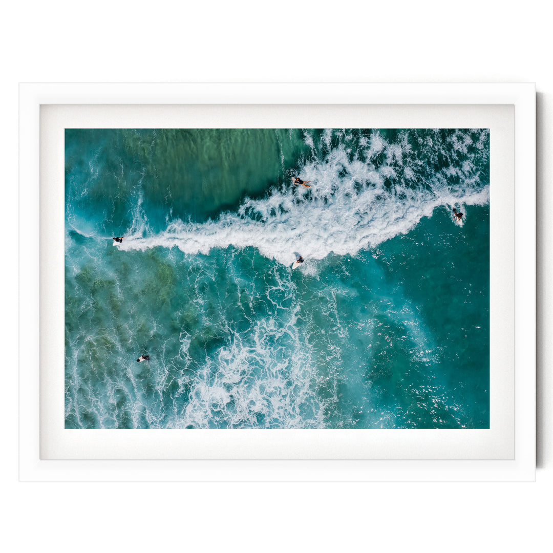 a group of people surfing on a large, foamy wave in the ocean.