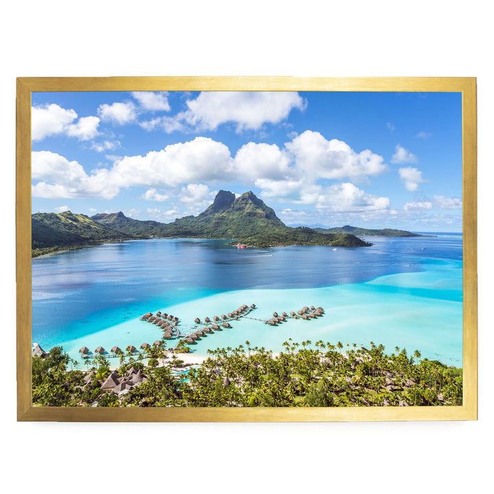 a tropical island with crystal clear turquoise waters, surrounded by lush green vegetation and dotted with several small islands.