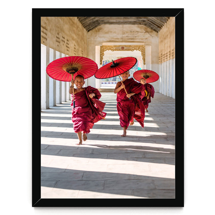 A group of people wearing red robes and carrying red umbrellas are walking down a hallway with a high ceiling and arched windows.