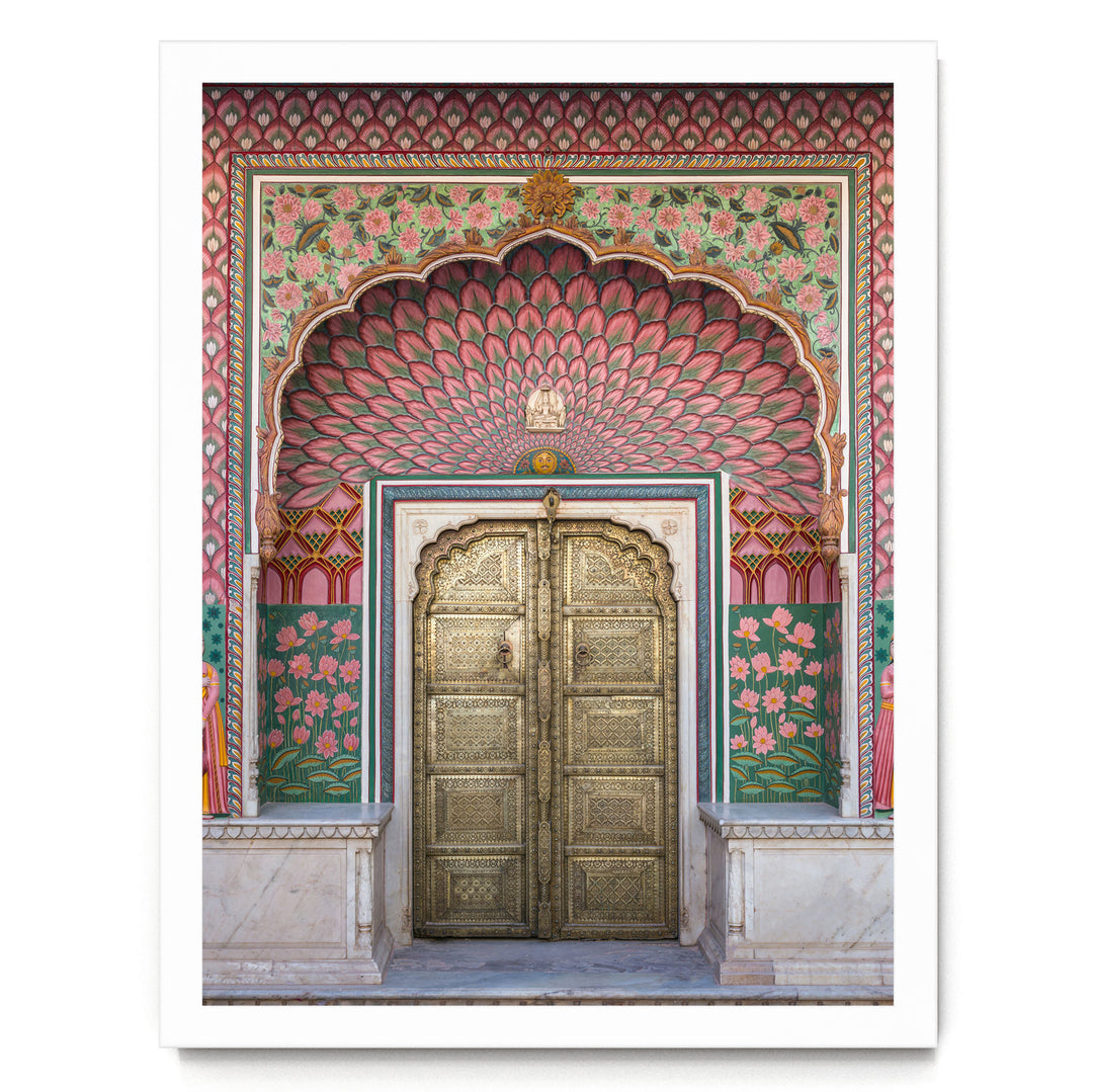 a beautifully decorated doorway with intricate patterns and vibrant colors, including pink, green, and gold elements.